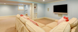 basement remodel concept with couch and wall mounted tv