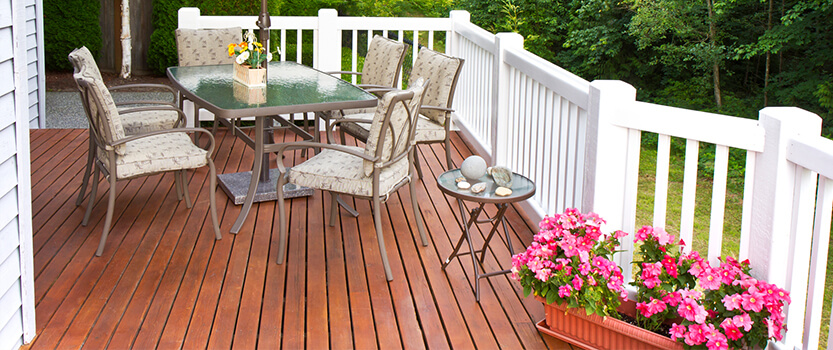mahogany deck with white fence deck furniture flowers