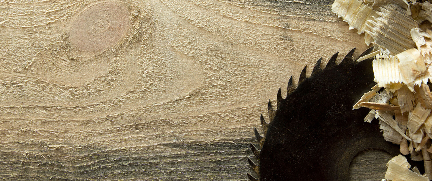 circular saw blade on wood board with saw dust